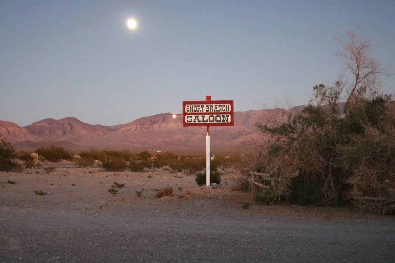The saloon roadside sign at dusk